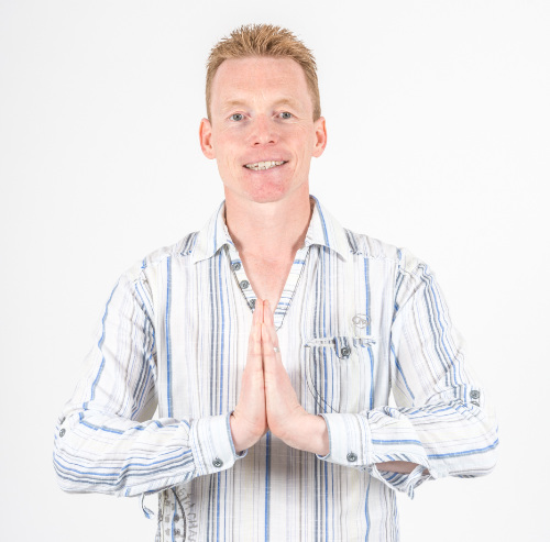 Karl Jeffery the meditation teacher, greeting you with hands held pressed together to show respect and honour for you 